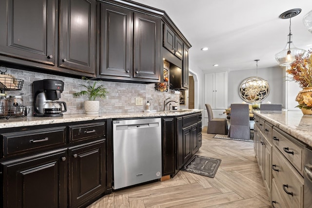 kitchen featuring decorative backsplash, light parquet floors, sink, dishwasher, and hanging light fixtures