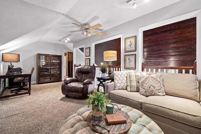 living room featuring carpet flooring, ceiling fan, a textured ceiling, track lighting, and vaulted ceiling