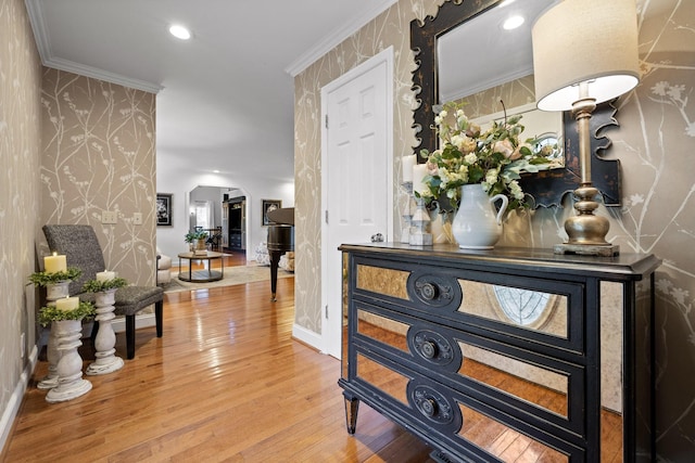 hall with hardwood / wood-style flooring and crown molding