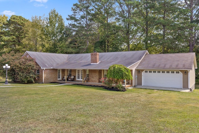 ranch-style home featuring covered porch, a garage, and a front lawn