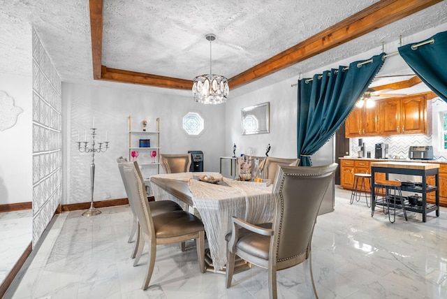 dining area with a tray ceiling, a textured ceiling, and an inviting chandelier