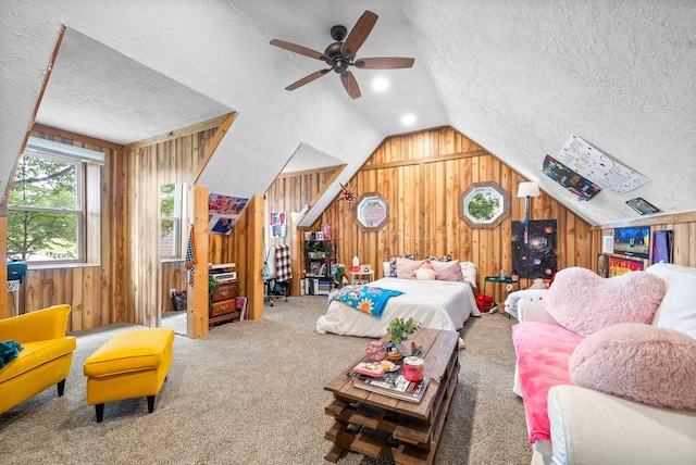 bedroom with carpet flooring, lofted ceiling, wood walls, and a textured ceiling