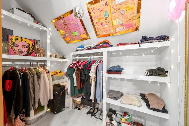 walk in closet featuring vaulted ceiling