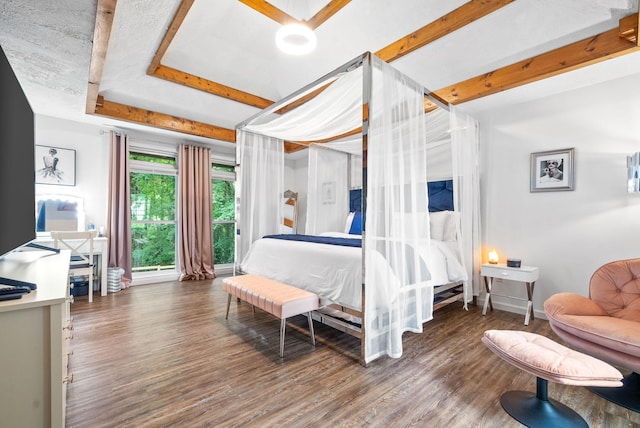 bedroom with dark hardwood / wood-style flooring and a tray ceiling