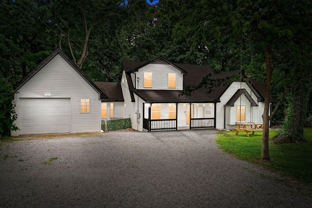 view of front of property with covered porch and a garage