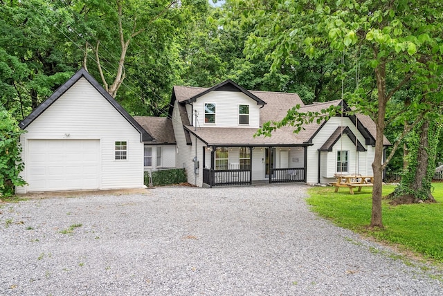 view of front of home with a porch, a garage, and a front lawn