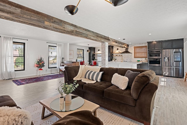 living room with light hardwood / wood-style flooring and a textured ceiling