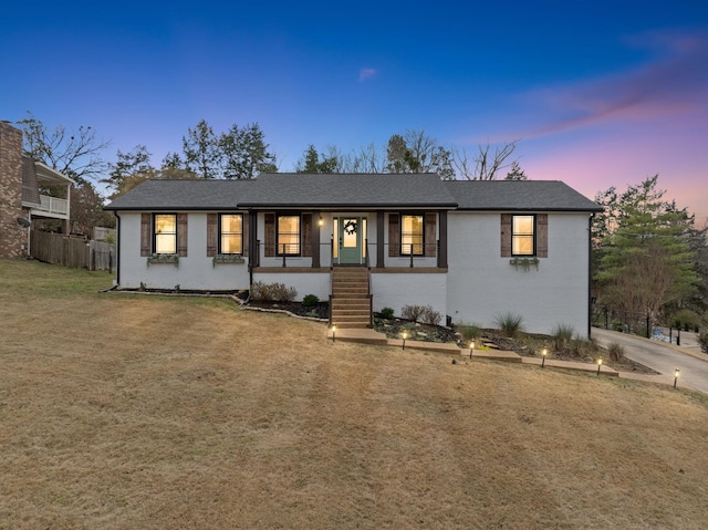 view of front of house featuring a yard and covered porch