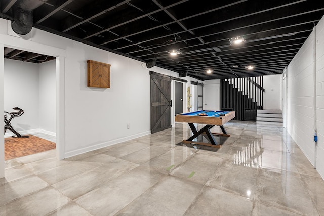 rec room with a barn door, pool table, and concrete floors