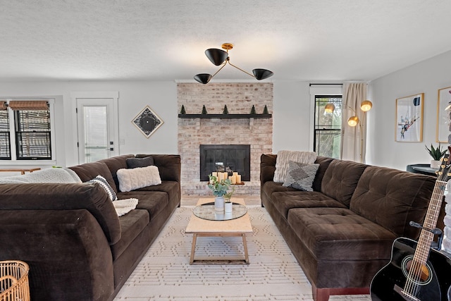 living room featuring a textured ceiling and a fireplace