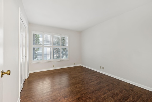 spare room with dark wood-type flooring