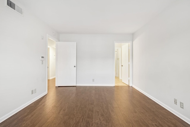 spare room featuring dark wood-type flooring