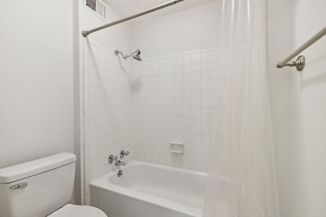 bathroom featuring shower / tub combo and toilet