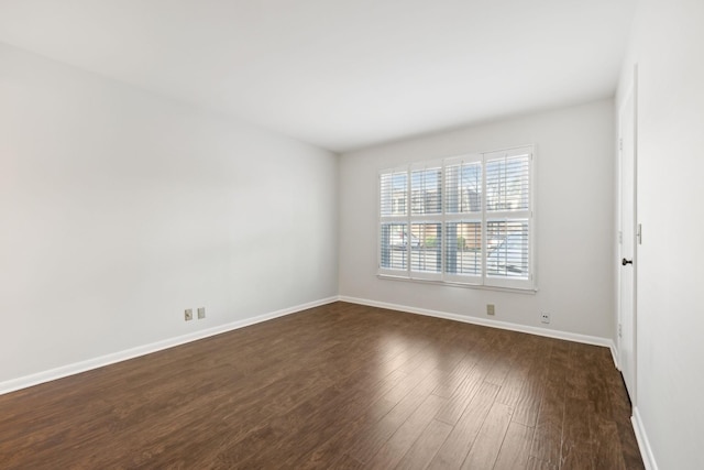 unfurnished room featuring dark hardwood / wood-style floors