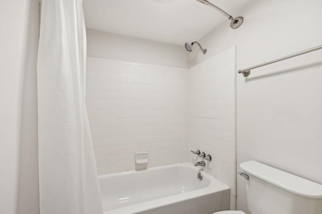 bathroom featuring shower / tub combo and toilet