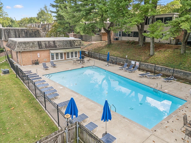 view of pool featuring central AC and a patio