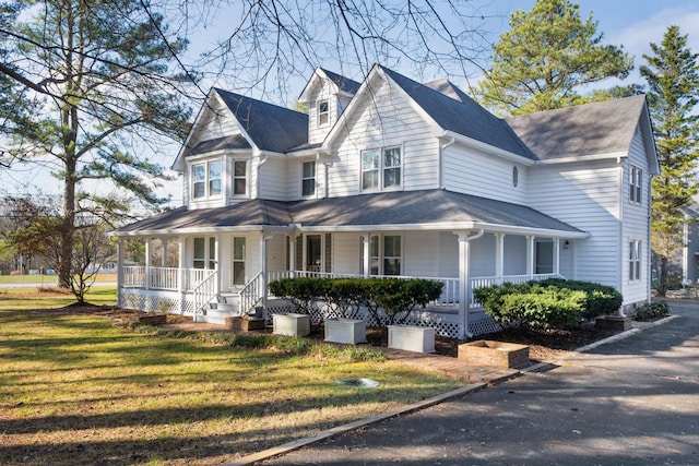 view of front facade with covered porch and a front yard