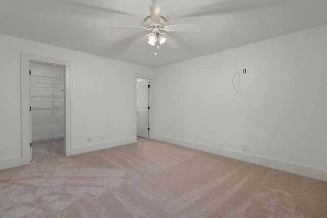 empty room with ceiling fan and light colored carpet