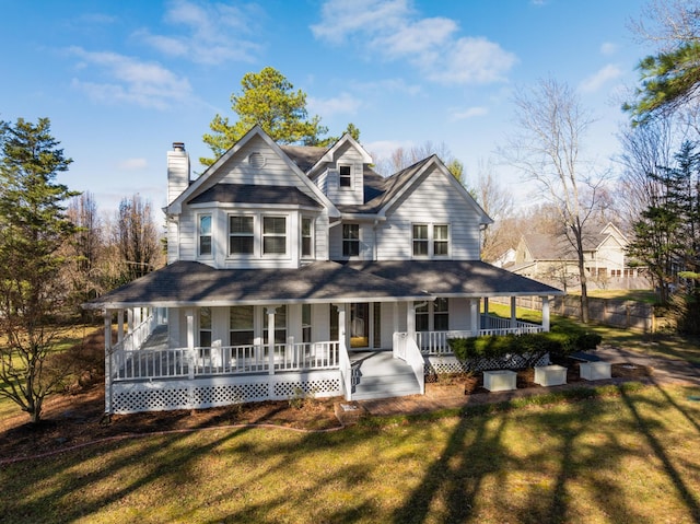 farmhouse inspired home with covered porch and a front yard