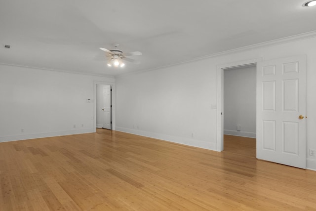 empty room with ceiling fan, light hardwood / wood-style floors, and crown molding