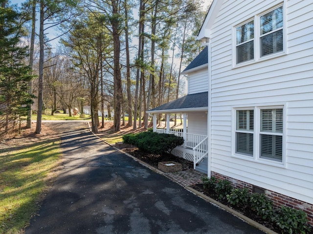 view of side of home featuring a porch