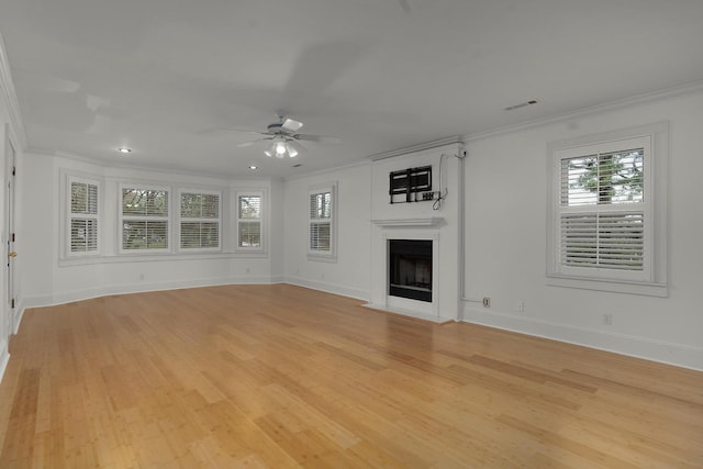 unfurnished living room featuring light wood-type flooring, ceiling fan, and ornamental molding