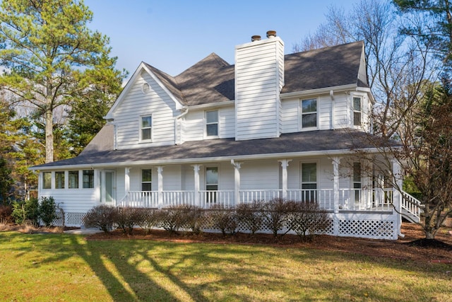 view of front of property with covered porch and a front lawn