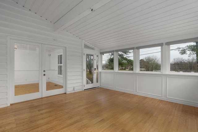 unfurnished sunroom featuring vaulted ceiling with beams and wood ceiling