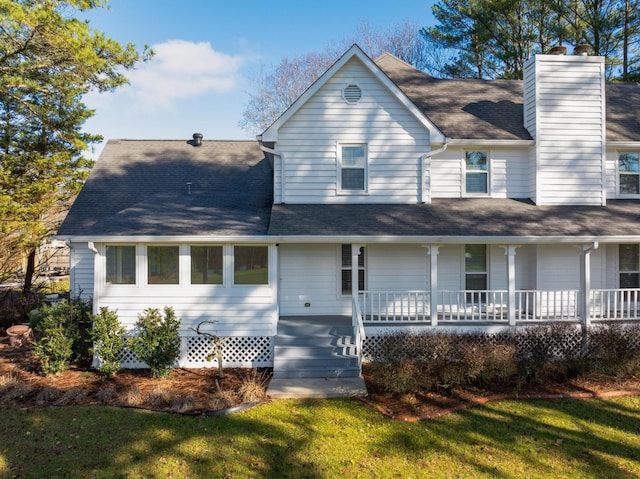 view of front of home with a porch and a front lawn