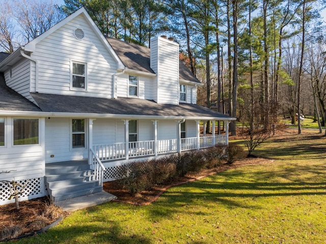 farmhouse inspired home with a front lawn and a porch