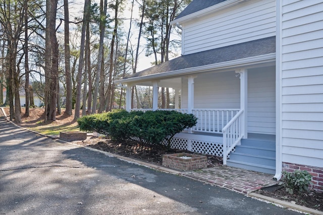 view of exterior entry featuring covered porch