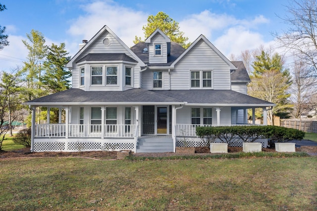 farmhouse with covered porch and a front yard