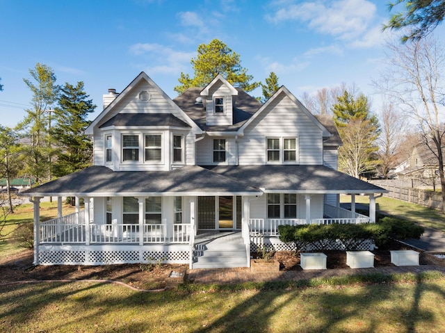 farmhouse-style home featuring covered porch and a front lawn