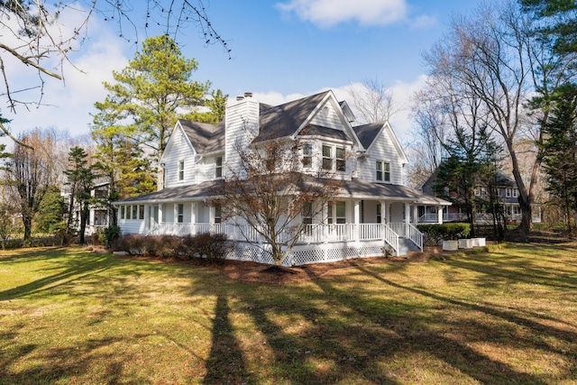 view of side of property featuring a lawn and a porch