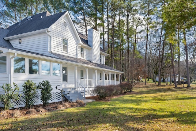 view of front of house featuring a front lawn and covered porch