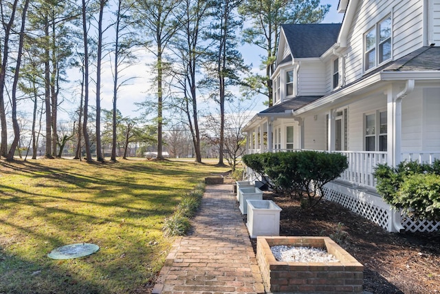 view of yard with covered porch