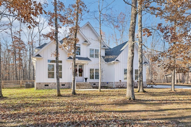 modern farmhouse featuring central air condition unit and a front lawn