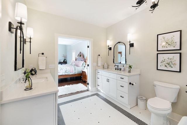 bathroom with hardwood / wood-style floors, vanity, and toilet