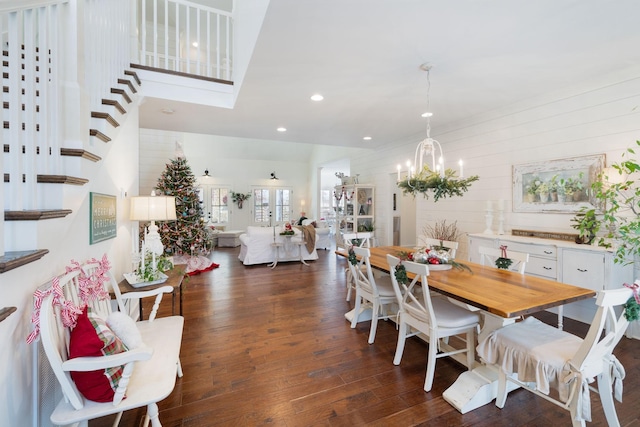 dining room with dark hardwood / wood-style flooring and an inviting chandelier