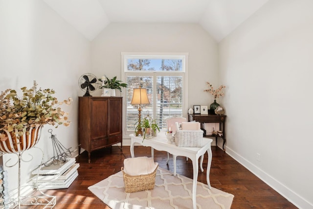 sitting room with dark wood-type flooring and vaulted ceiling