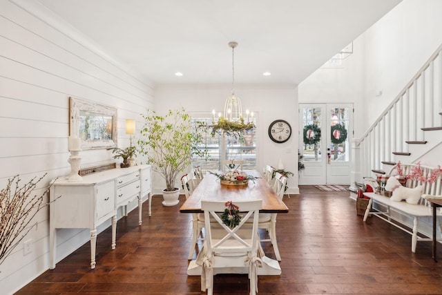 dining space featuring dark hardwood / wood-style flooring and an inviting chandelier