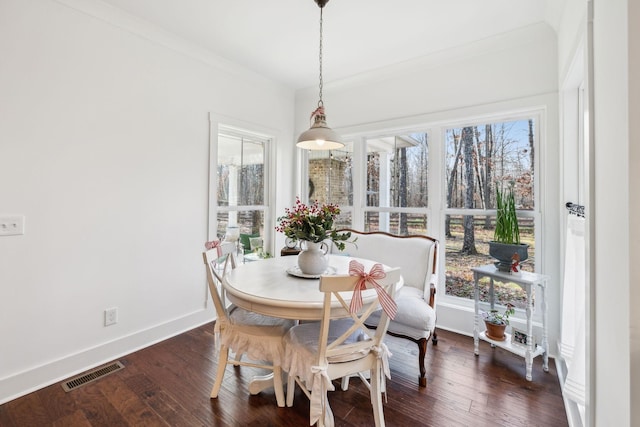 dining area featuring crown molding and dark hardwood / wood-style floors