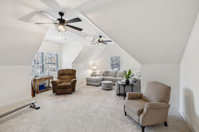 living area featuring carpet, ceiling fan, and lofted ceiling