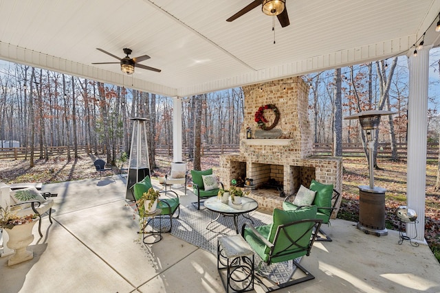 view of patio / terrace with an outdoor brick fireplace and ceiling fan