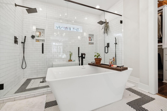 bathroom with tile patterned flooring and independent shower and bath