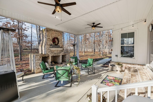 sunroom / solarium featuring ceiling fan and an outdoor brick fireplace