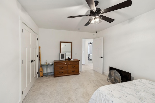 bedroom featuring light colored carpet and ceiling fan