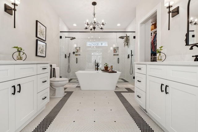 full bathroom featuring tile patterned flooring, vanity, plus walk in shower, and a notable chandelier