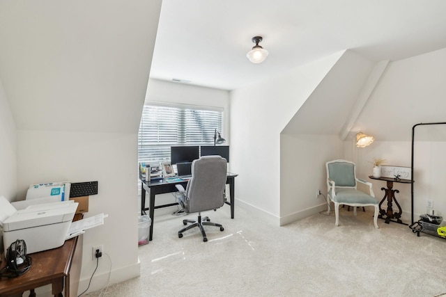 carpeted home office with lofted ceiling