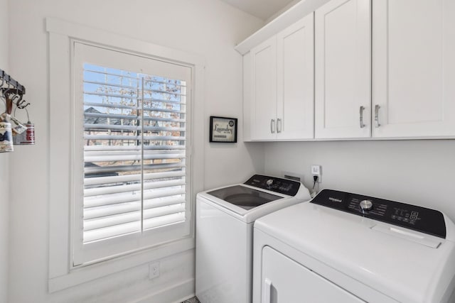 laundry room with cabinets and washer and clothes dryer